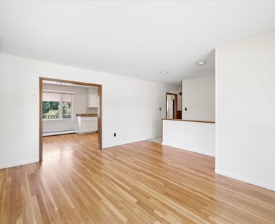 Spacious, light-filled living area with hardwood floors, seamlessly connecting to the kitchen for easy entertaining.
