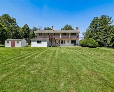 Inviting multi-level home with spacious backyard and convenient shed, perfect for outdoor activities and storage.