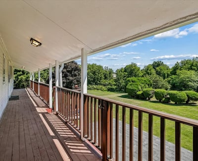 Enjoy expansive outdoor views from this spacious covered balcony, perfect for relaxing or entertaining.