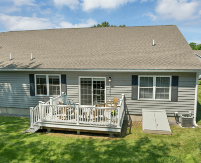 Cozy home features a spacious deck, perfect for outdoor gatherings and enjoying the scenic backyard.