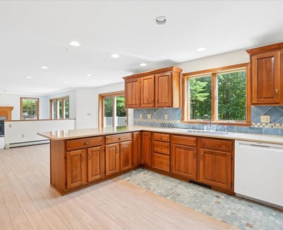Spacious kitchen featuring warm wood cabinetry, ample natural light, and modern appliances, perfect for family gatherings.