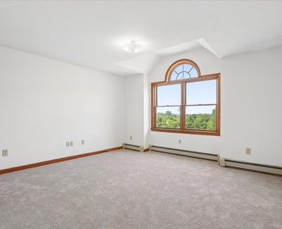 Spacious room featuring large window with scenic views, perfect for customization to your taste.