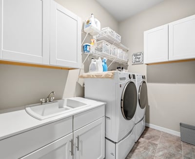 Laundry room off of the entry and walks through to primary suite.