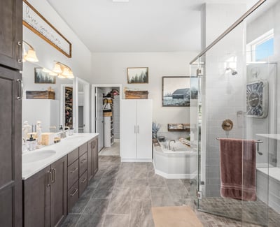 Primary Suite with attached 5 piece bath and walk in closet.
