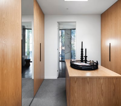 Modern entryway featuring elegant wood cabinetry, contemporary decor, and ample natural light for a welcoming atmosphere.