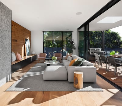 Stunning modern living space featuring large windows, stylish decor, and seamless indoor-outdoor flow.
