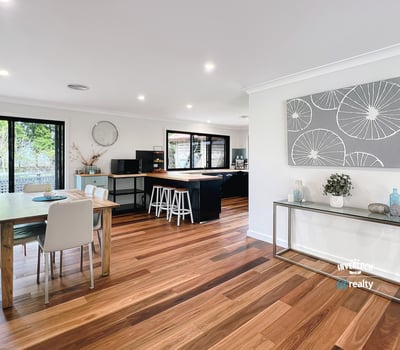 Spacious open-plan living area with modern finishes, large windows, and abundant natural light throughout.