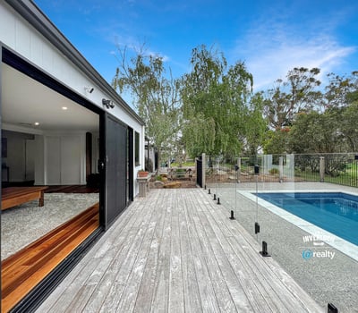 Modern home featuring open spaces, seamless indoor-outdoor flow, and a refreshing pool set amidst nature.