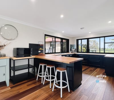 Bright and functional kitchen featuring modern appliances, ample counter space, and scenic views through expansive windows.