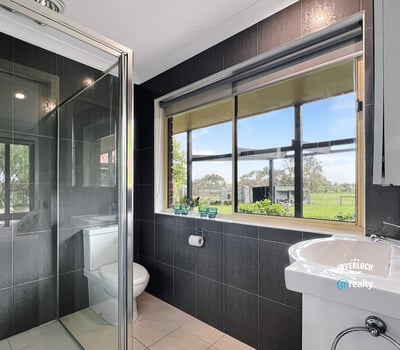 Bright bathroom featuring modern fixtures and scenic views, perfect for relaxation and comfort.
