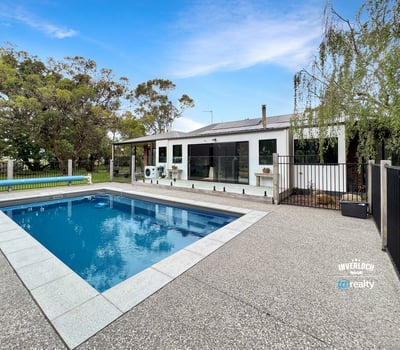 This spacious property features a large pool and versatile outdoor space, ideal for entertaining and relaxation.