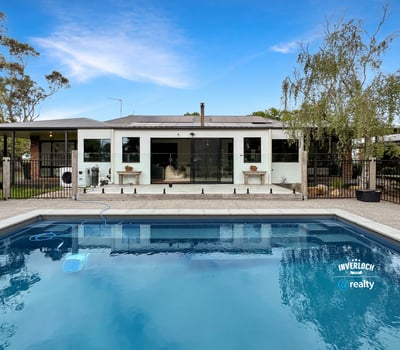 Contemporary home featuring a spacious poolside area, ideal for outdoor entertaining and relaxation.