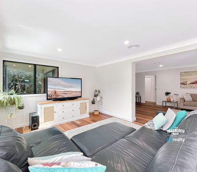 Bright and spacious living area featuring modern furnishings and large windows for natural light.