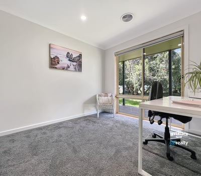 Bright and spacious room with large windows, offering peaceful views and ample natural light for productivity.