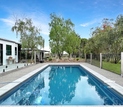This property features a refreshing pool and landscaped yard, perfect for outdoor gatherings and relaxation.
