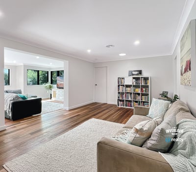 Spacious living area with modern finishes, large windows, and an inviting atmosphere perfect for relaxation.