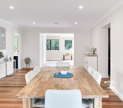 Spacious open-concept living area featuring a modern dining space and abundant natural light throughout.