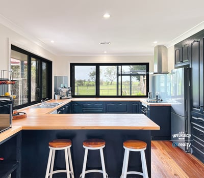 Modern kitchen featuring sleek cabinetry, expansive windows with scenic views, and a spacious island for entertaining.