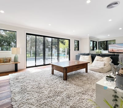 Spacious living area featuring large windows, modern furnishings, and seamless indoor-outdoor flow for relaxation and entertainment.