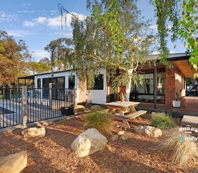 Discover this modern home featuring an inviting outdoor space, pool, and beautiful landscaping for relaxed living.