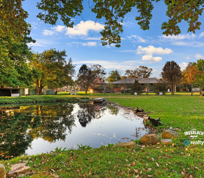 Discover a picturesque waterfront property surrounded by lush greenery and ample outdoor space for relaxation.