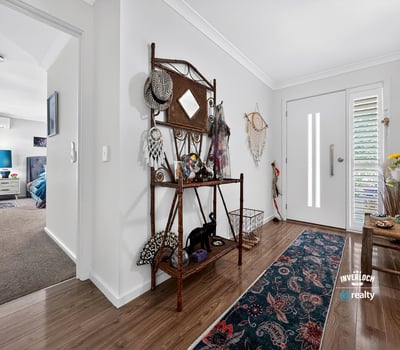 Bright and inviting entrance features unique decor, leading to spacious living areas filled with natural light.