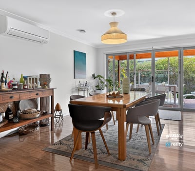 Bright dining area featuring modern decor, large windows, and seamless outdoor access for entertaining.