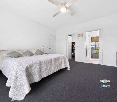 Spacious bedroom featuring ample natural light and direct access to adjoining rooms for added convenience.