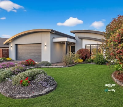 Contemporary home with unique architecture, vibrant landscaping, and a spacious outdoor area for entertaining.