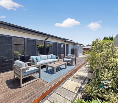 Discover a spacious outdoor area perfect for gatherings, featuring comfortable seating and lush landscaping.
