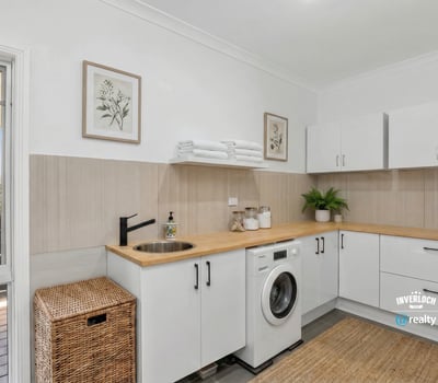 Bright and functional laundry space featuring modern appliances and ample storage for a streamlined experience.