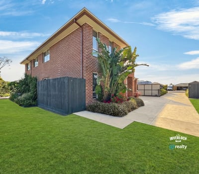Spacious two-story home with ample outdoor space, lush landscaping, and convenient parking in a welcoming neighborhood.