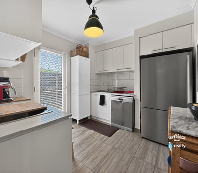 Modern kitchen featuring sleek appliances, ample storage, and natural light, perfect for culinary enthusiasts.