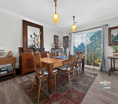 Discover a warm dining area featuring natural light, vintage decor, and inviting outdoor views.