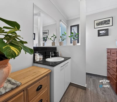 Bright bathroom featuring modern fixtures, ample storage, and abundant natural light from large windows.