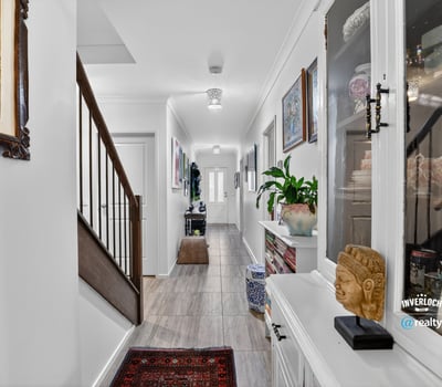 Discover a modern hallway featuring natural light, tasteful decor, and a welcoming ambiance throughout.