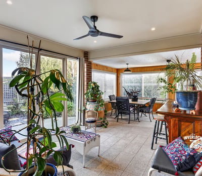 Bright and spacious sunroom featuring ample natural light, perfect for relaxing and entertaining.