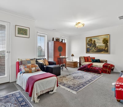 Spacious living area features abundant natural light, unique decor elements, and cozy textiles perfect for gatherings.