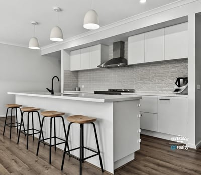 Modern kitchen featuring sleek cabinetry, ample counter space, and a spacious island perfect for gatherings.