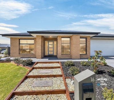 Modern home featuring a welcoming entry, landscaped yard, and large windows for abundant natural light.