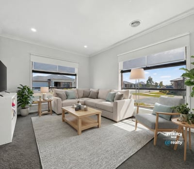 Bright and inviting living room featuring large windows, modern furnishings, and a spacious layout for relaxation.