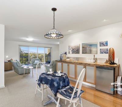 Bright, open-plan living space seamlessly connects the kitchen, dining, and cozy lounge area, perfect for entertaining.