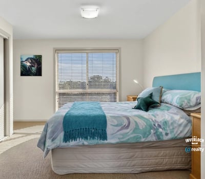 Bright and inviting bedroom featuring natural light, comfortable furnishings, and a peaceful atmosphere.