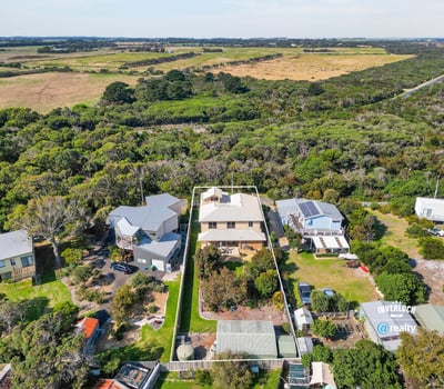 This spacious property features a large yard, surrounded by lush greenery and stunning natural vistas.