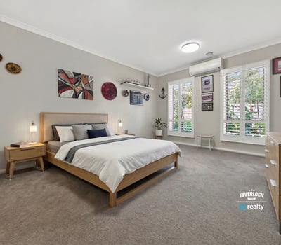 Spacious bedroom featuring large windows, contemporary decor, and ample storage in a tranquil setting.