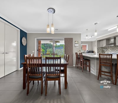 Modern kitchen and dining area with ample natural light and direct access to an outdoor space.