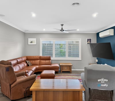 Spacious living area featuring a modern layout, comfortable seating, and abundant natural light throughout.
