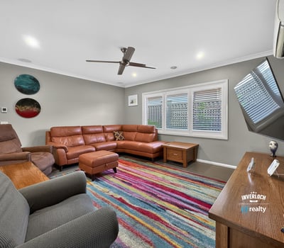 Spacious living area features contemporary furnishings and vibrant decor, perfect for relaxation and entertaining.