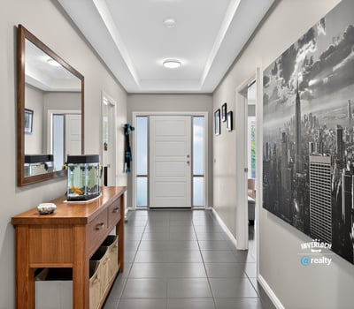 Spacious entryway featuring contemporary decor, natural light, and functional layout for welcoming guests.