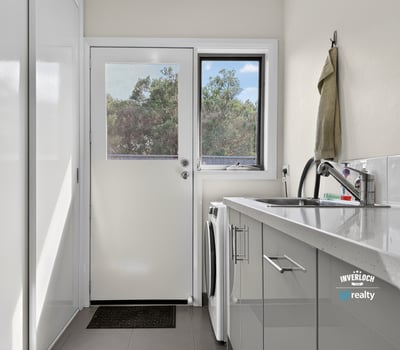 Bright and functional laundry area with modern appliances and natural light, perfect for everyday tasks.